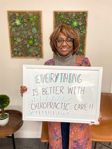 Chiropractic Walnut Creek CA Patient Holding Sign With Testimonial