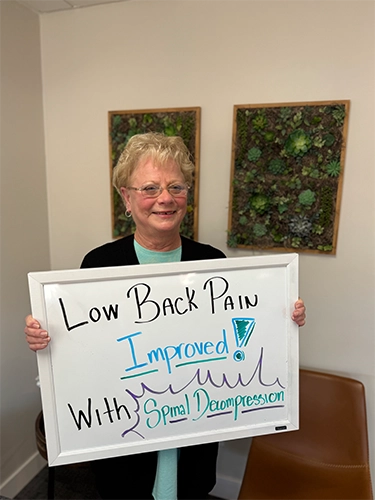 Chiropractic Walnut Creek CA Patient Holding Sign With Testimonial