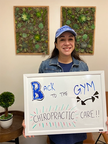 Chiropractic Walnut Creek CA Patient Holding Sign With Testimonial
