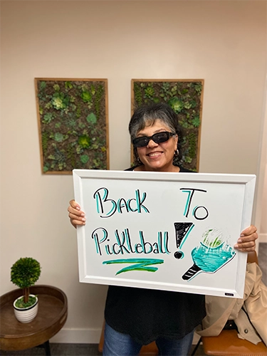 Chiropractic Walnut Creek CA Patient Holding Sign With Testimonial