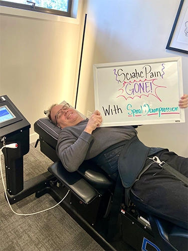 Chiropractic Walnut Creek CA Patient Holding Sign With Testimonial