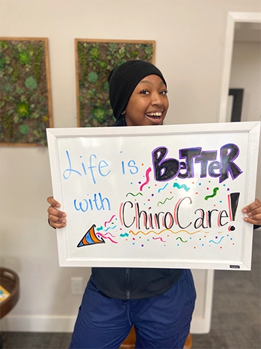 Chiropractic Walnut Creek CA Patient Holding Sign With Testimonial