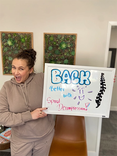 Chiropractic Walnut Creek CA Patient Holding Sign With Testimonial