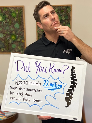 Chiropractor Walnut Creek CA Brandon Holmes Holding Sign